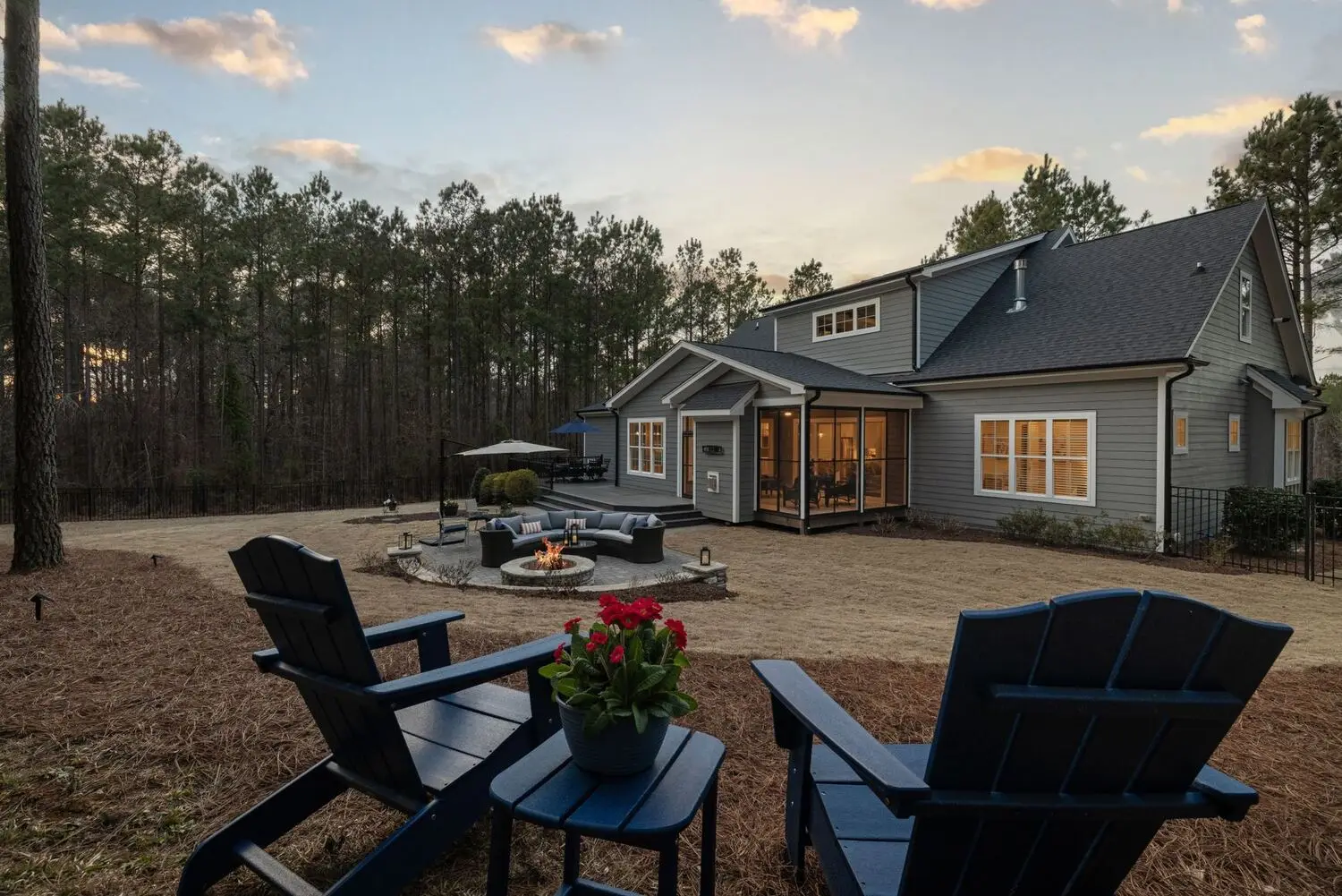 Backyard with fire pit and seating at dusk