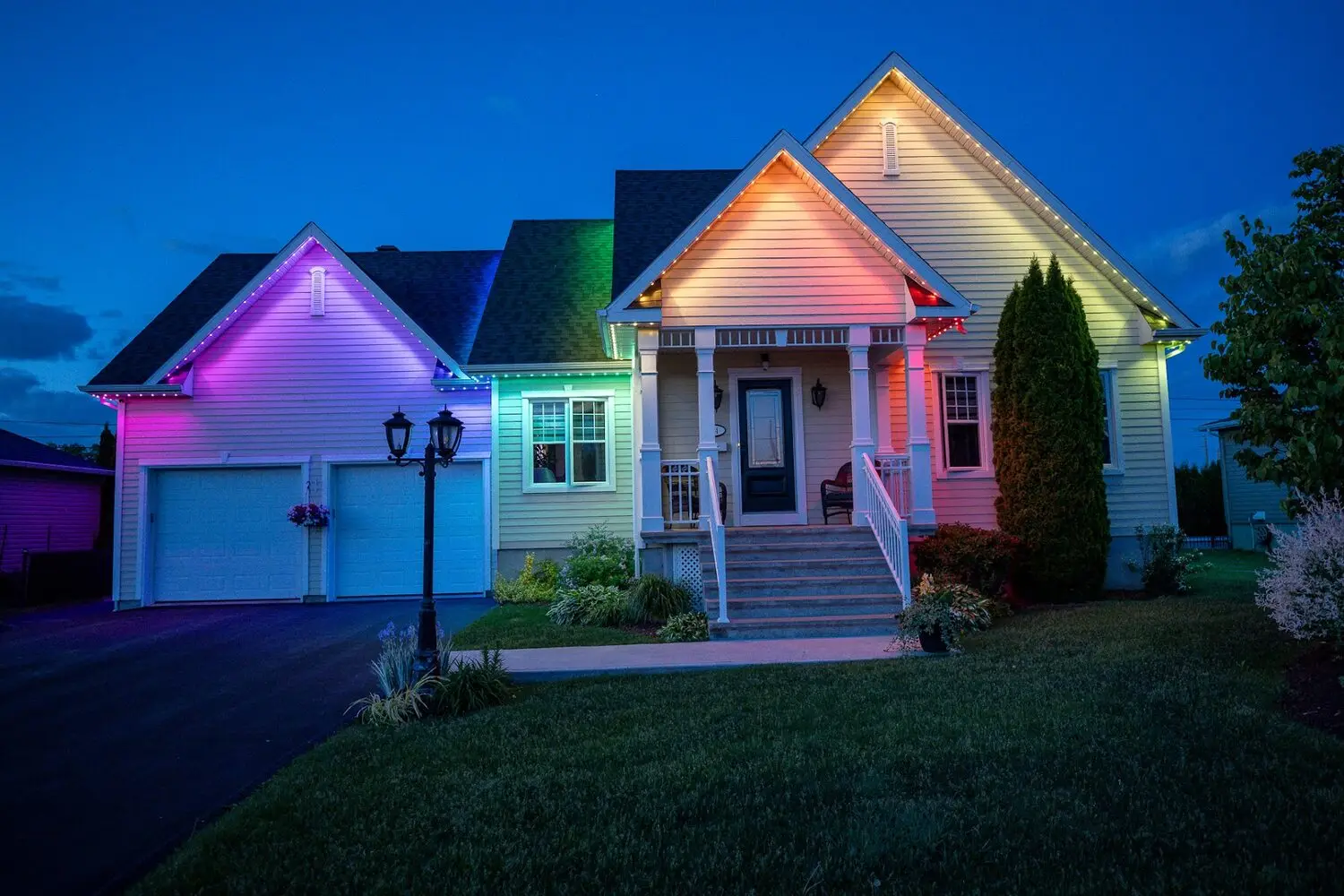 Home lit in blended pink, green and blue across the roofline