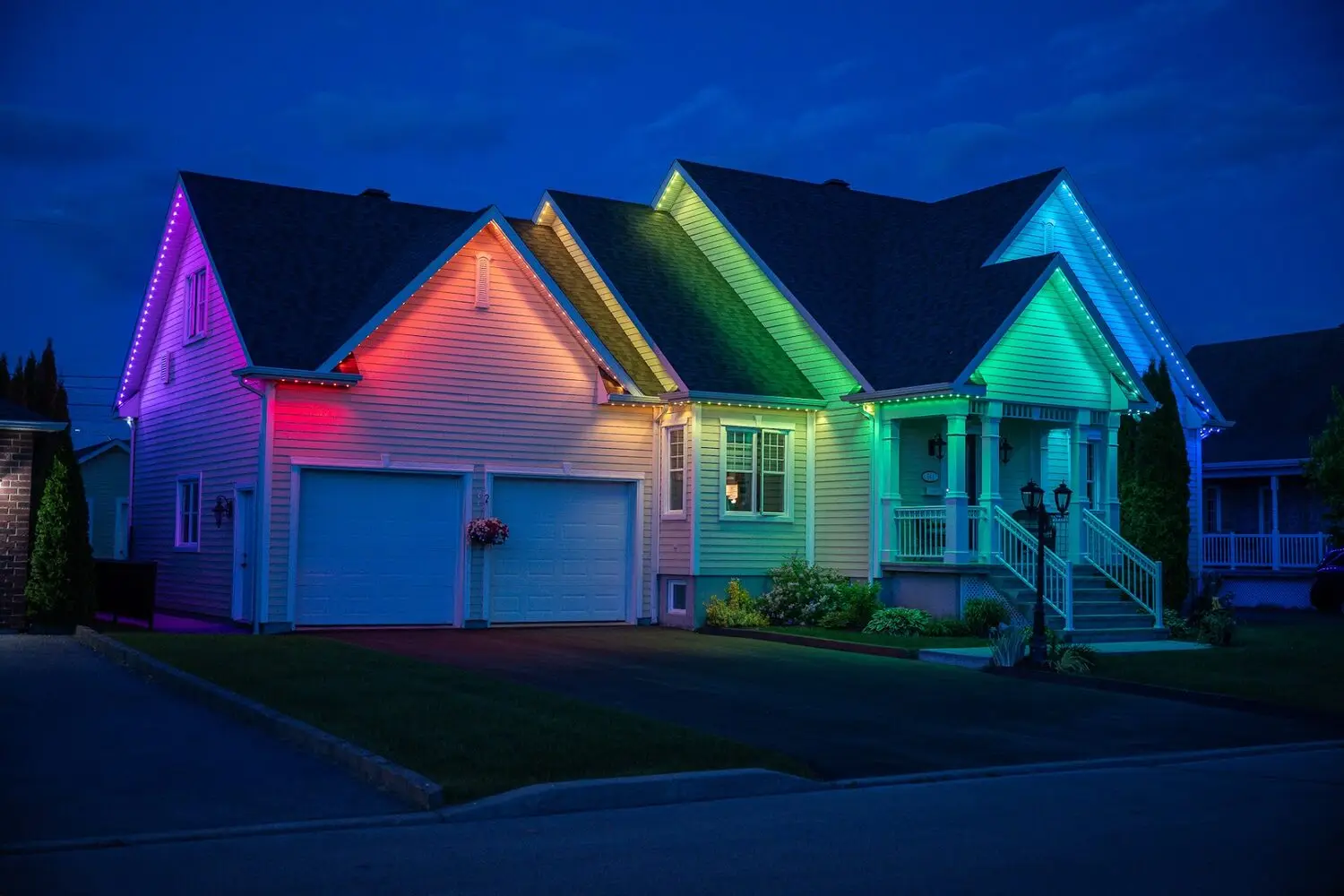 Home lit in a graduated sweep of colour from violet through to green