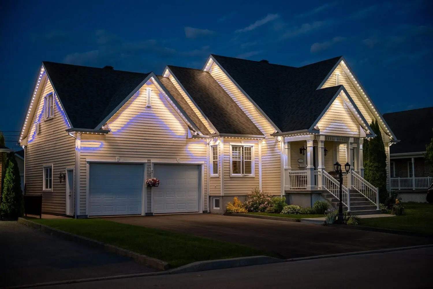 Home lit in warm white with colour accents picking out the roof peaks