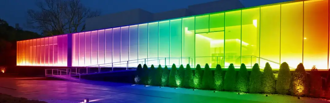 Modern office building with lit glass facade at dusk