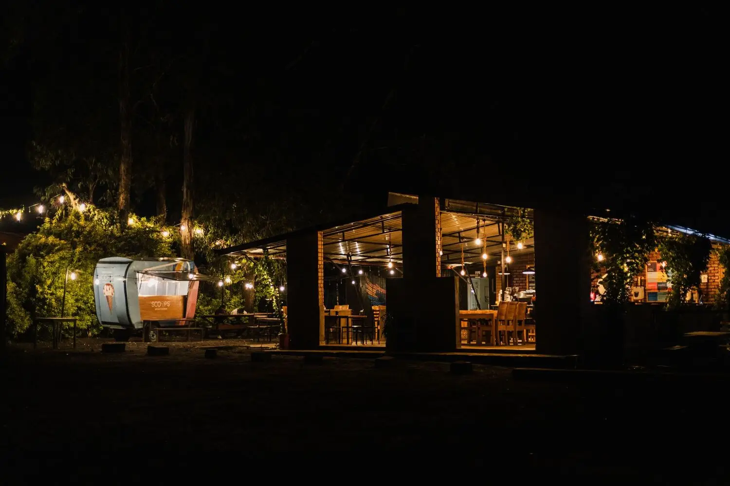 Outdoor restaurant patio lit with warm string lighting